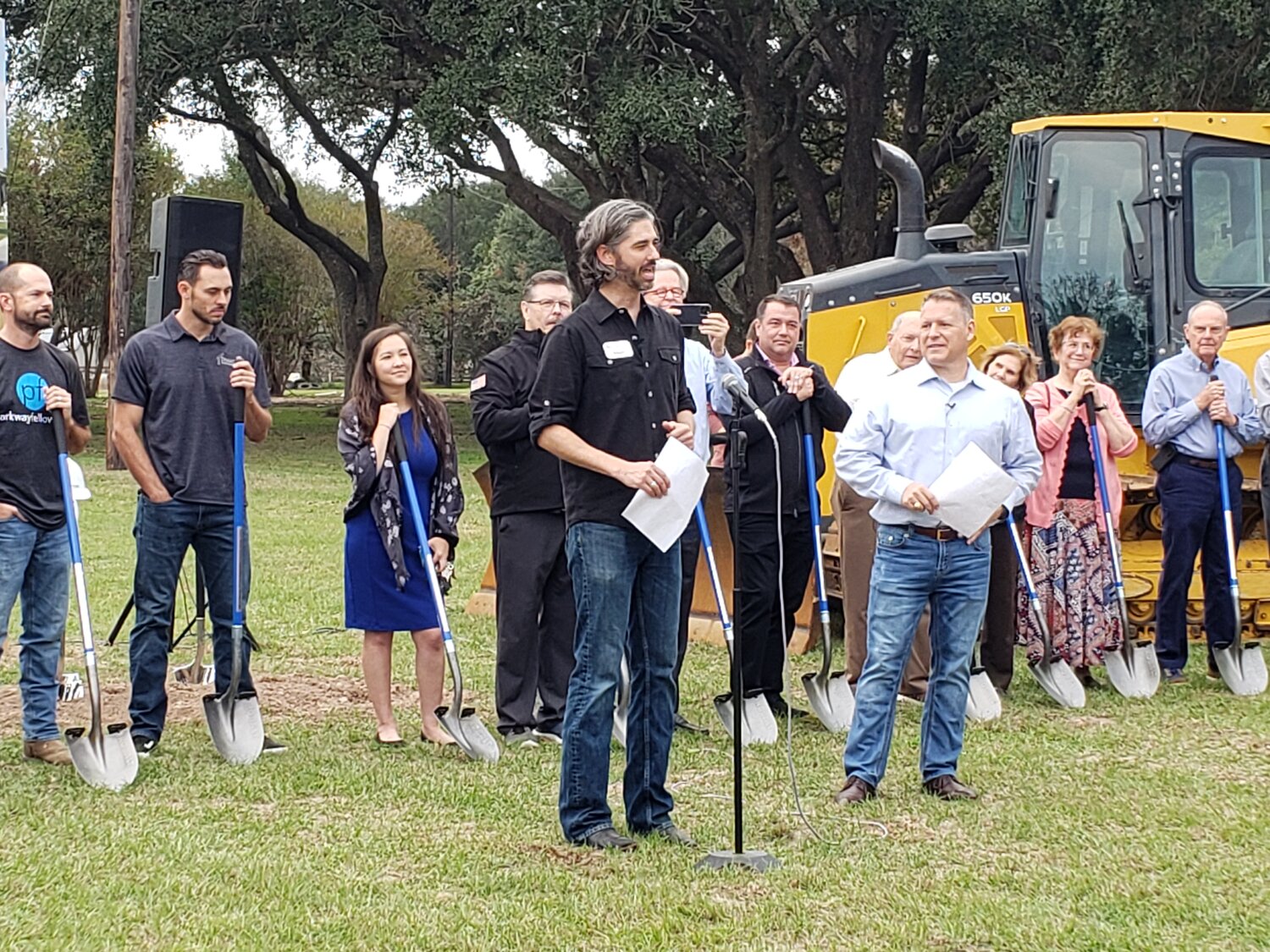 Adam Jungeblut (center), residency director at Parkway Fellowship’s north Katy campus, leads the groundbreaking ceremony held November 19th at the church’s new location at 5911 Morton Road in Katy. Senior Pastor Mike McGowan (right, in white) also spoke at the event, which attracted a large crowd of several hundred people.